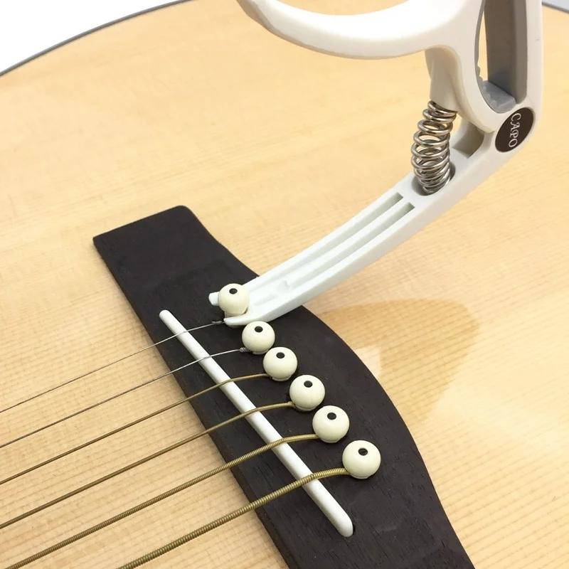 Пластиковый каподастр для 6-ст – обзор и цена Guitar Tuner Clip